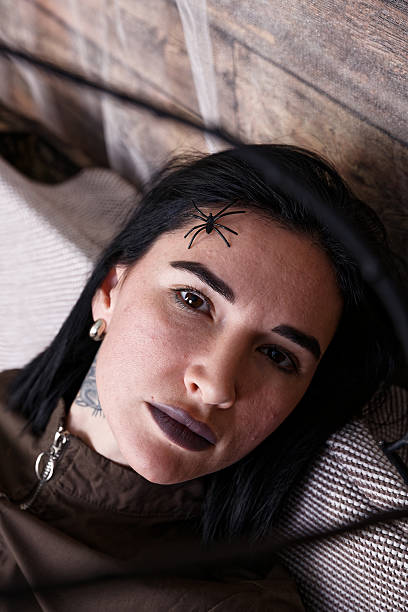 istock Woman with Gothic Makeup and a Halloween-Themed Spider 2227018266