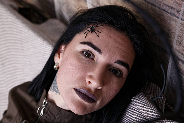 istock Woman with Gothic Makeup and a Halloween-Themed Spider 2227018275