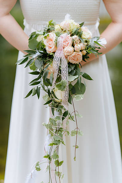 istock Bride Holding Cascading Pastel Bouquet 2227019535