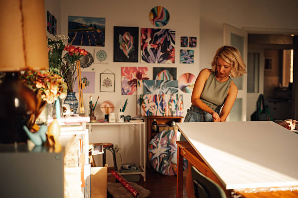 istock Female artist preparing canvas in sunny art studio 2227019698