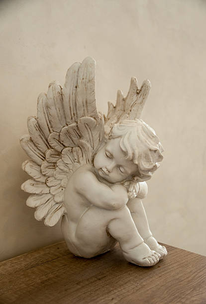 istock Plaster angel figurine stands on table, copy space 2227020046