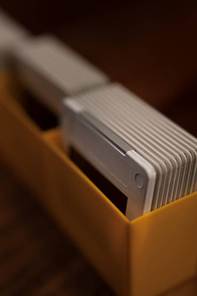 Close-up of old slides in a yellow box, evoking memories of past travels and experiences