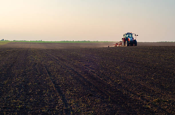 istock Tractor sowing on agricultural field 2227023983