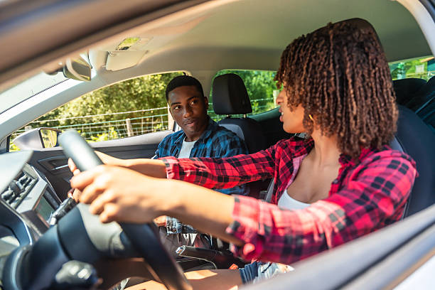 istock Young couple driving and having fun on road trip 2227026132