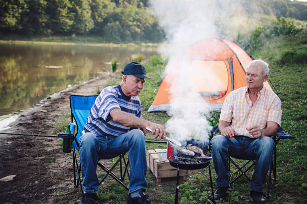 istock Elderly Men Grilling Food While Camping Outdoors 2227029267