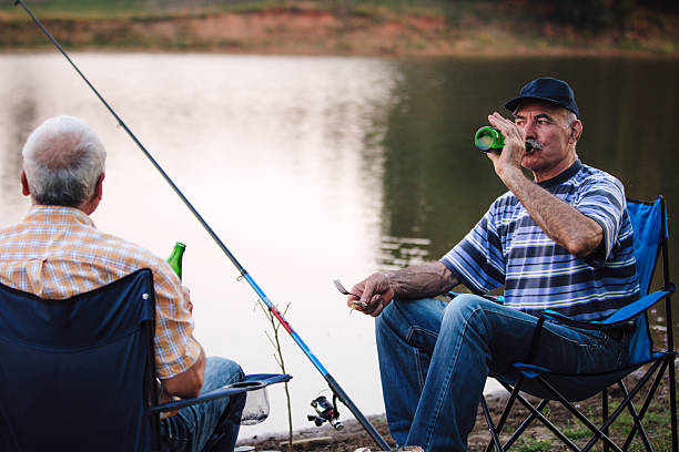 istock Relaxing Moment: Man Enjoys Drink by Water 2227029317