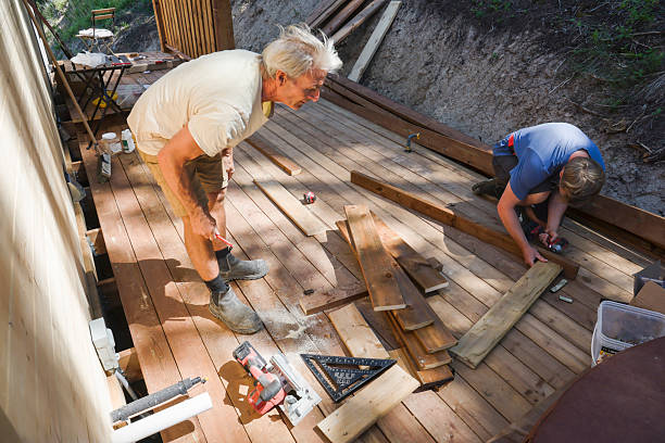 istock Father and adult son build deck 2227031795