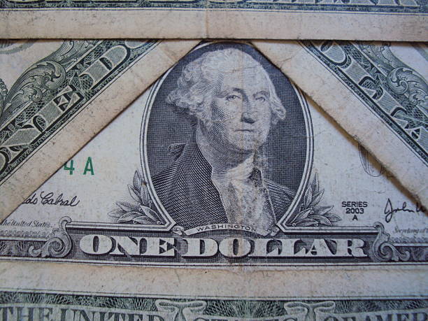 Close-up shot of unrecognizable person holding a rolled up money ( US Dollars Currency )