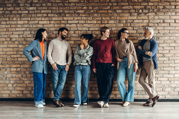 istock Startup team members talking and leaning against brick wall 2227036187