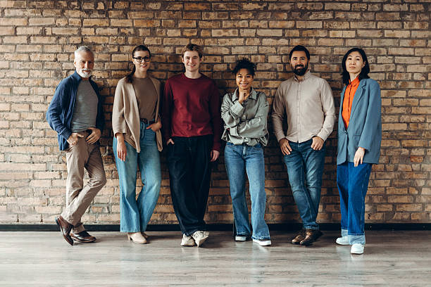 istock Group of diverse multinational team posing by brick wall: colleagues collaboration and innovation 2227036212