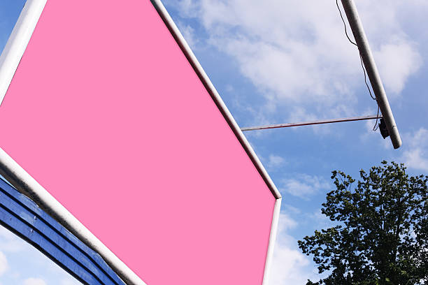 Blank sign for commercial message. Outdoor signage with sky and tree.
