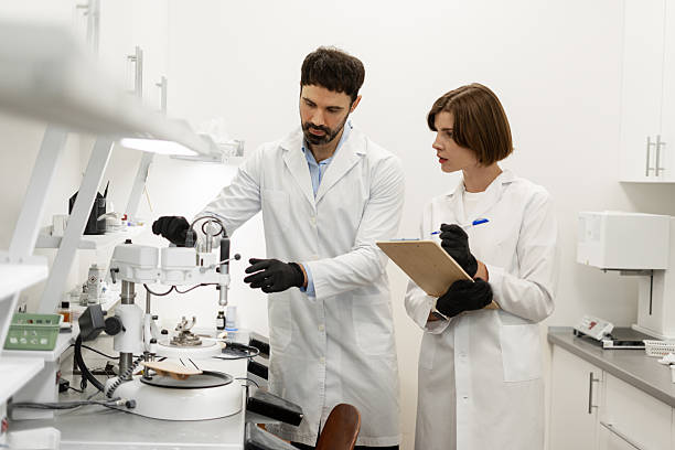 istock Team using equipment in laboratory discussing about a dental prosthesis 2227037082