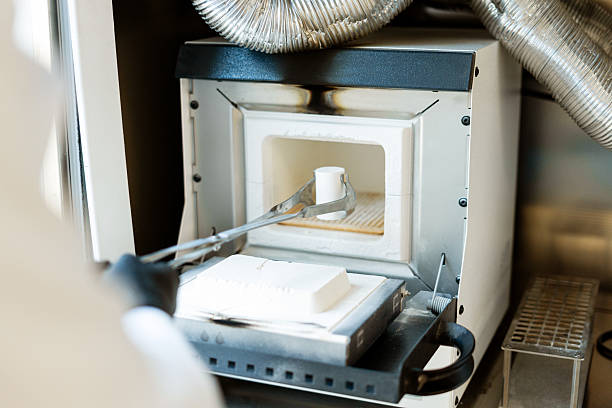 istock Scientist placing sample in laboratory furnace for analysis 2227037107
