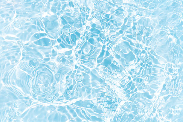 istock Blue water with ripples on the surface. Defocus blurred transparent blue colored clear calm water surface texture with splashes and bubbles. Water waves with shining pattern texture background. 2227037825
