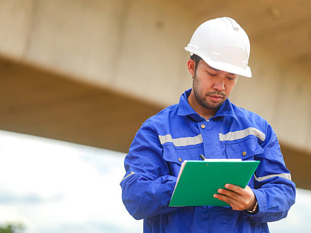 istock Asian engineer working at site of a large building project,Thailand people,Work overtime at construction site 2227039284