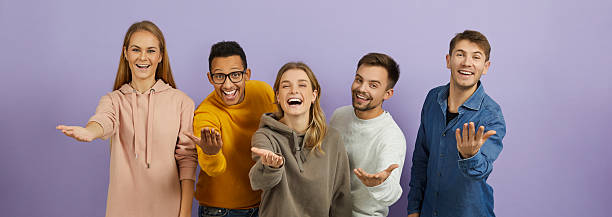 istock Team of happy young diverse people saying 'Come here', smiling and doing inviting gesture 2227039764