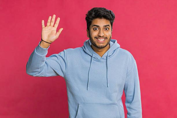 istock Happy man smiling friendly waving hands gesturing hello greeting or goodbye, meeting invitation 2227041639