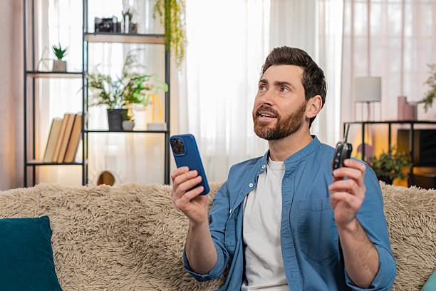 istock Man focused on smartphone map, planning trip, gesturing while thinking about route, holding car keys 2227041698