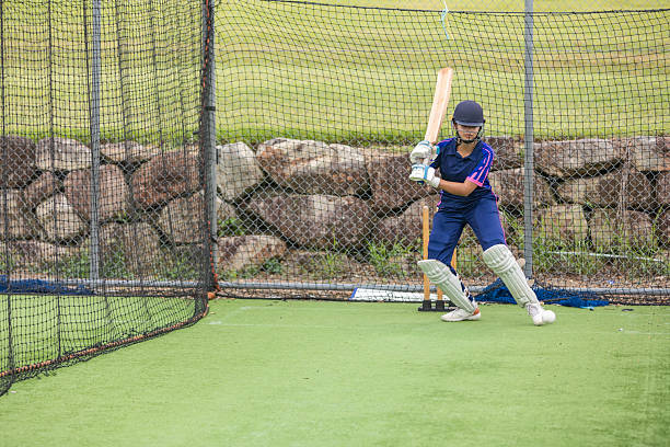 istock Teenage girl cricket player practicing batting 2227047431