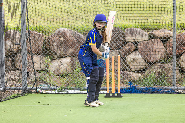 istock Teenage girl cricket player practicing batting 2227047447