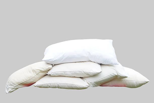istock Stack of used white pillows without pillowcases, isolated on grey background. Concept, equipment in bedroom. Hygiene, cleanliness, and regular maintenance of pillows for better health. 2227053818