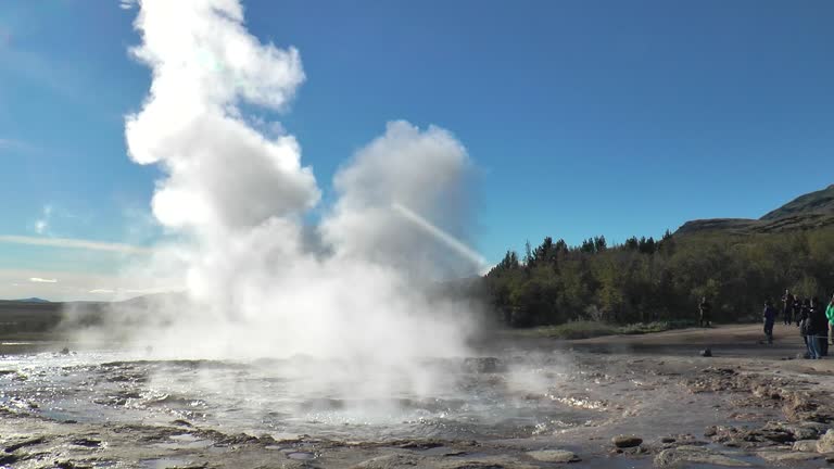 Geyser erupts with impressive power in Iceland under clear blue sky