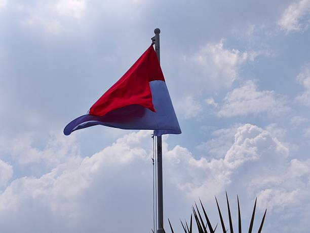 Church and country, a flag waves next to a Christian church steeple in Hinton West Virginia.