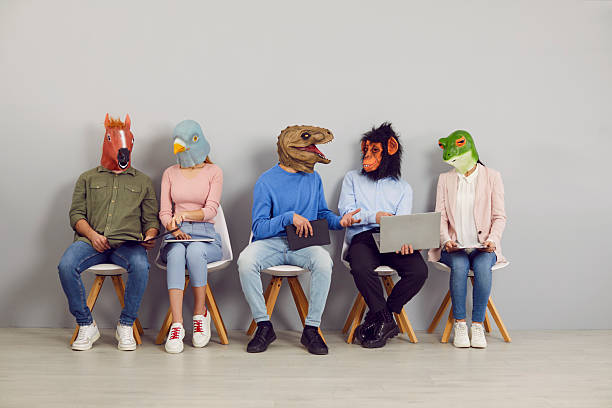 istock People in funny animal masks talking and using devices while waiting for job interview 2227056235