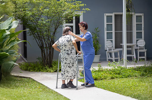 istock Elderly woman exercise walking in backyard with caregiver. 2227056454