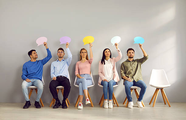 istock Group of young people thinking, holding speech bubbles and sharing their opinions 2227056711