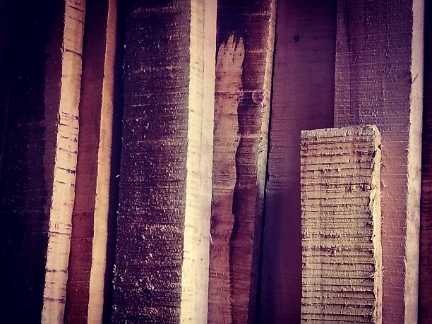 istock Stacked  Wooden Planks Creating a Textured Rustic Appearance in Warm Lighting 2227059023