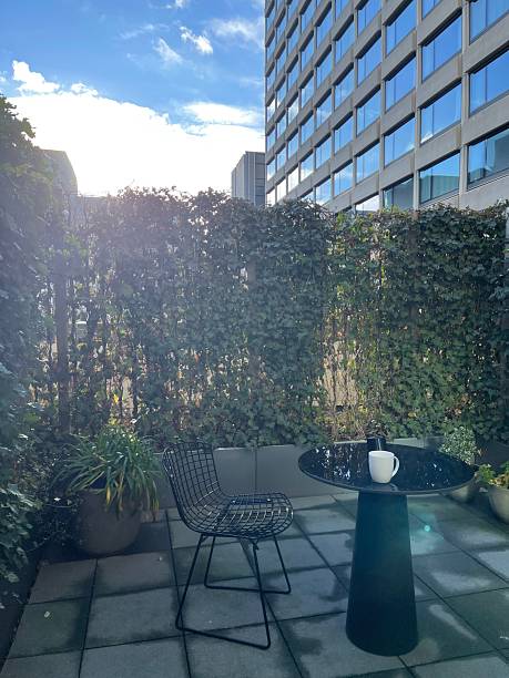 istock Courtyard with black table and chairs with modern building 2227059981