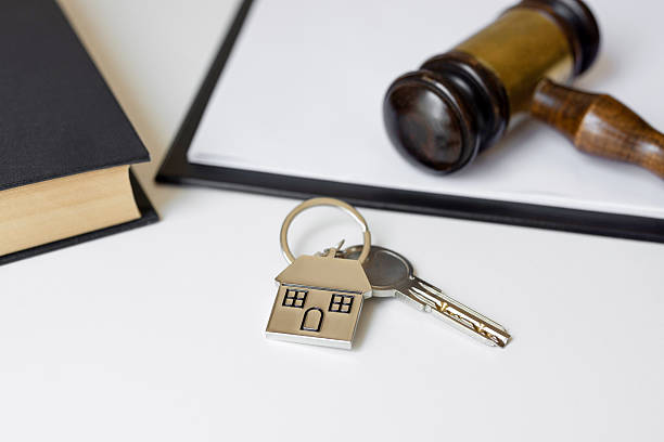 istock Gavel,notepad,book and house key on table 2227068107