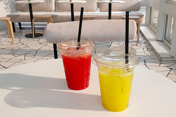 istock Bright drinks on a white table in a modern cafe with natural sunlight 2227068176