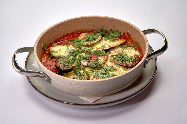 Deliciously Baked Dish Featuring Fresh Vegetables and Herbs in a Flavorful Tomato Sauce, Perfectly Served in a Decorative Casserole Dish
