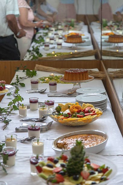 istock Guests serving themselves from an elegant dessert buffet table during a daytime celebration. The variety of colorful fruit, crème brûlée, puddings, and flan encourages sharing and joy. 2227070241