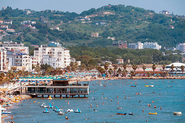 A view of beach goers beating the heat of the sun around Madre Perla restaurant in Durres beach , Albania. - June 16, 2025
