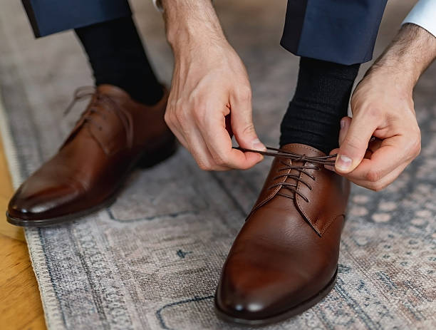 istock Man is lacing his shoe 2227074906