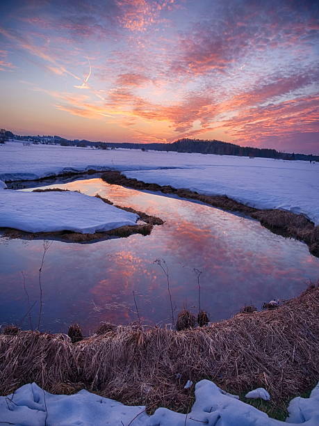 istock A beautiful sunset over a frozen lake with a river running through it 2227082659