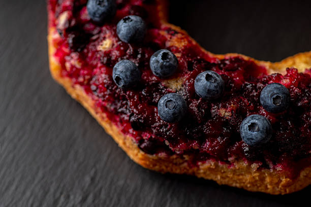 Homemade pie with blueberries on he black stone background