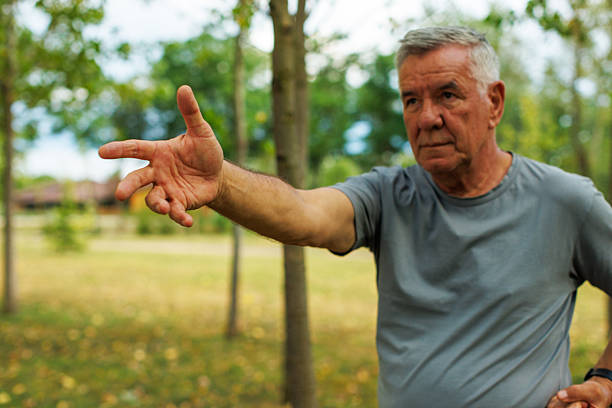 istock Focused Senior Man Practicing Tai Chi in Nature 2227084442