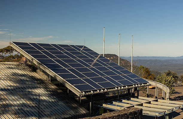istock Solar panels on building roof with mountain view. 2227084996