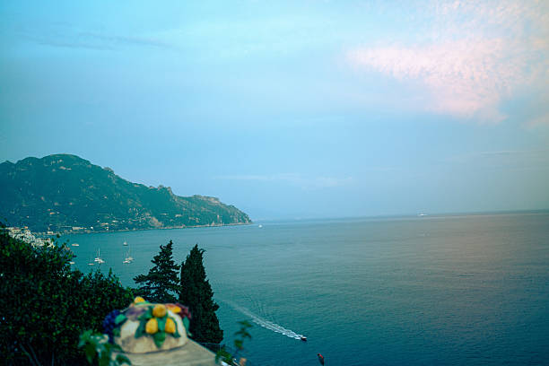 A stunning panoramic view of the Amalfi Coast with turquoise waters, dramatic cliffs, and colorful hillside villages.