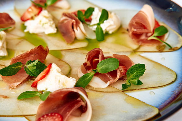 istock Delicate Charcuterie Plate Featuring Thinly Sliced Meats, Creamy Cheese, and Fresh Herbs Laid Elegantly on a Vibrant Platter for an Appetizing Presentation 2227086592