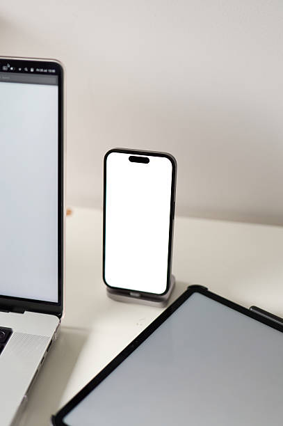 istock Smartphone with blank screen displaying near laptop and tablet on desk 2227087230