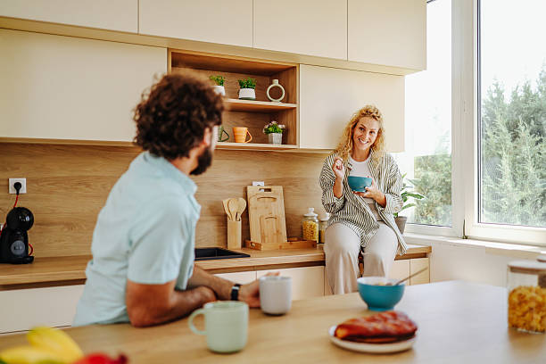 istock Couple enjoying breakfast and talking in modern kitchen 2227087707