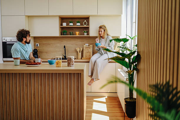 istock Couple enjoying breakfast and conversation in modern kitchen 2227087711