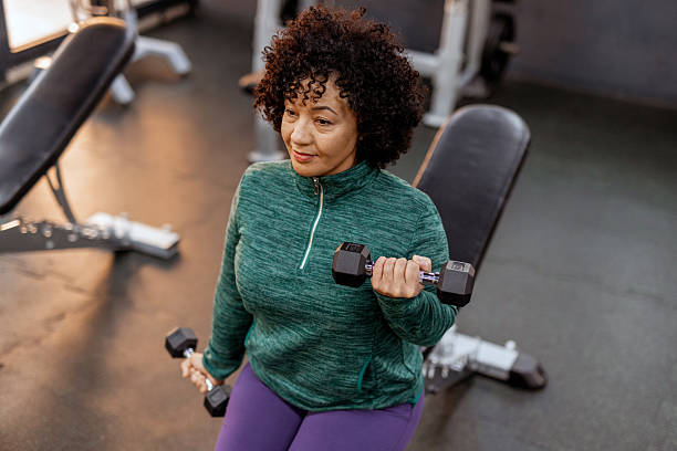 istock Plus-Size Woman Using Dumbbells for Strength Workout 2227091001