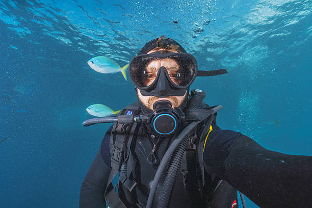 istock Diver taking a selfie underwater with tropical fish 2227091593