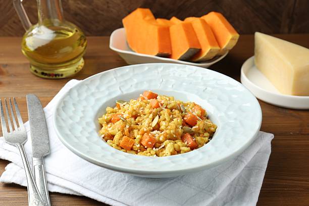 istock Delicious pumpkin risotto served on wooden table, closeup 2227093460